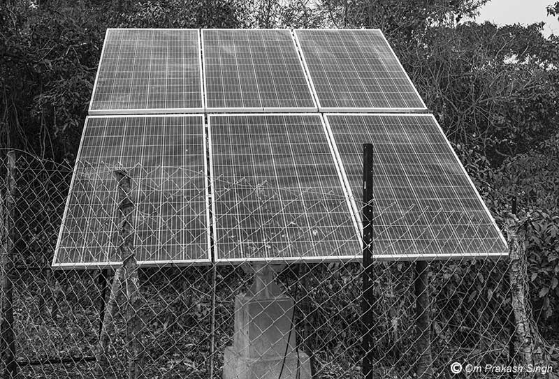 Optimizing traditional drinking water sources for accelerating change - solar panels which power the submersible pump in the spring-based sanitary well in Jiyatpani Tola, village Dumarpahar, district Dumka, Jharkhand